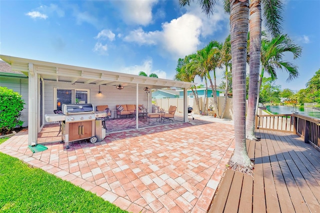 view of patio / terrace with a grill, fence, and a wooden deck