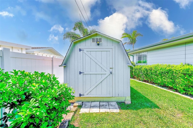 view of shed featuring fence