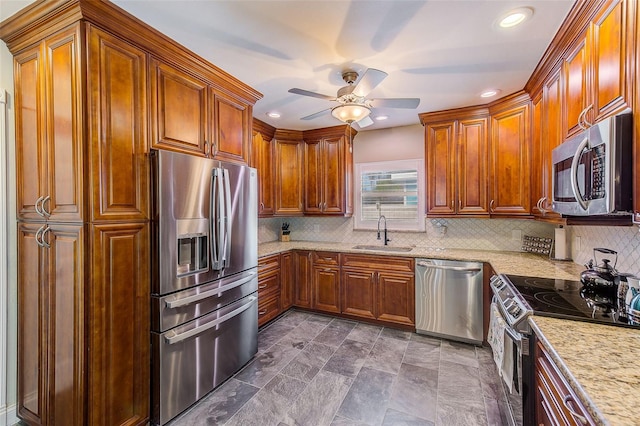 11035 Huron Rd, Saint Petersburg, FL 33708 - kitchen with stainless steel appliances, a sink, a ceiling fan, light stone countertops, and recessed lighting