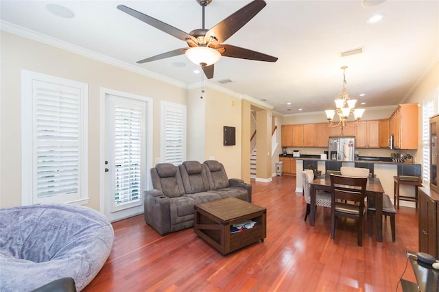 111 S Delaware Ave Unit 1, Tampa, FL 33606 - living room featuring ornamental molding, ceiling fan with notable chandelier, wood finished floors, and stairs