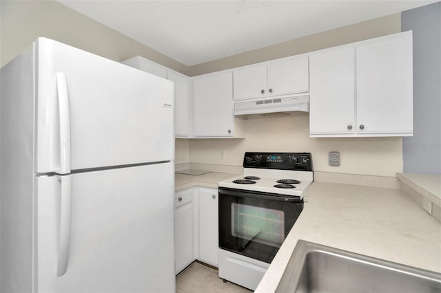 8013 Savannah Sunset Ln, Tampa, FL 33615 - kitchen with freestanding refrigerator, under cabinet range hood, a sink, electric stove, and light countertops