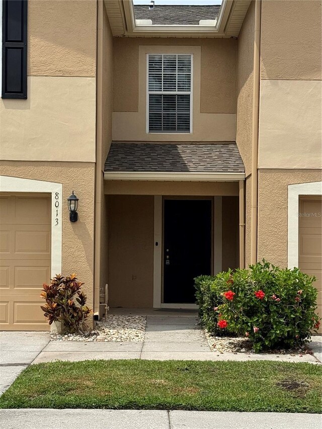 8013 Savannah Sunset Ln, Tampa, FL 33615 - view of exterior entry with stucco siding