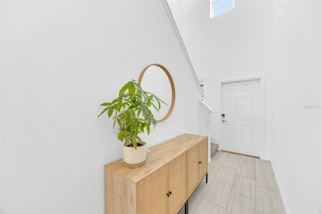 doorway to outside with stairway, baseboards, light tile patterned flooring, and visible vents