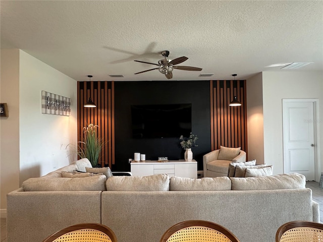 33034 Sand Creek Dr, Wesley Chapel, FL 33543 - living room with a ceiling fan and a textured ceiling