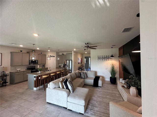 33034 Sand Creek Dr, Wesley Chapel, FL 33543 - living area with a textured ceiling, a ceiling fan, light tile patterned floors, and recessed lighting