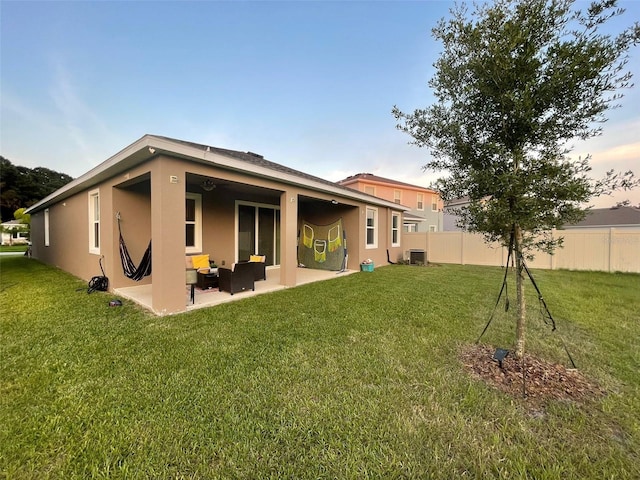 33034 Sand Creek Dr, Wesley Chapel, FL 33543 - rear view of property with stucco siding, a patio area, central AC, and an outdoor living space