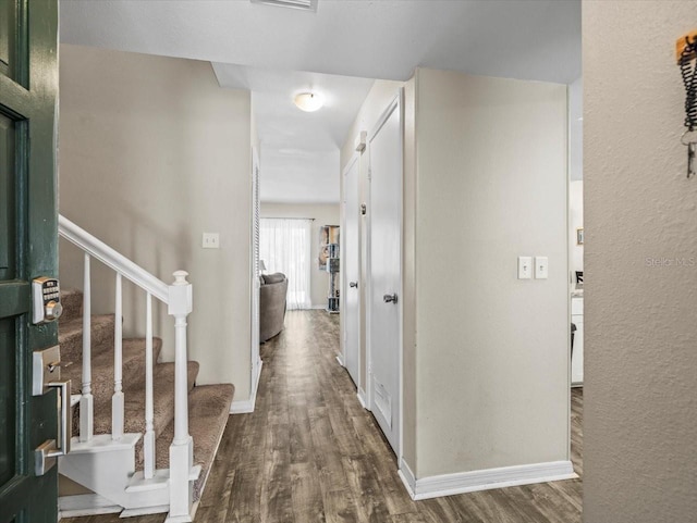 entrance foyer featuring stairway, baseboards, and dark wood finished floors