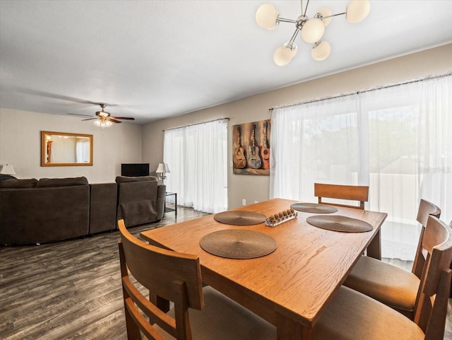 dining space with dark wood-style floors and a ceiling fan