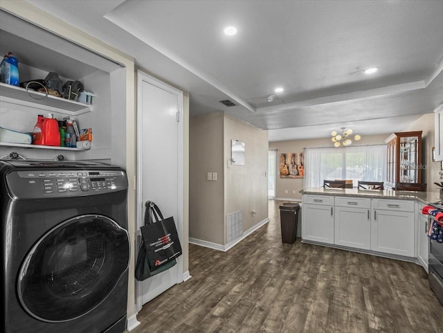 clothes washing area with dark wood-type flooring, visible vents, baseboards, and laundry area