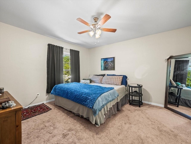 bedroom featuring ceiling fan, carpet flooring, and baseboards