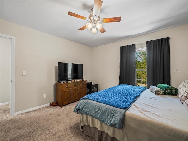 bedroom with light carpet, baseboards, and a ceiling fan