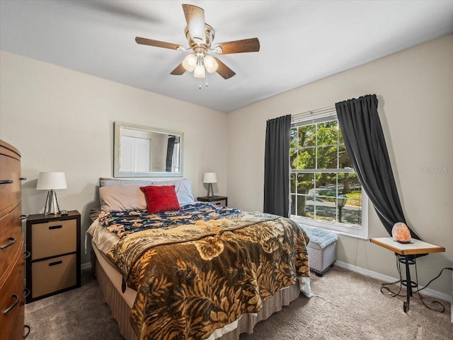 carpeted bedroom with baseboards and a ceiling fan