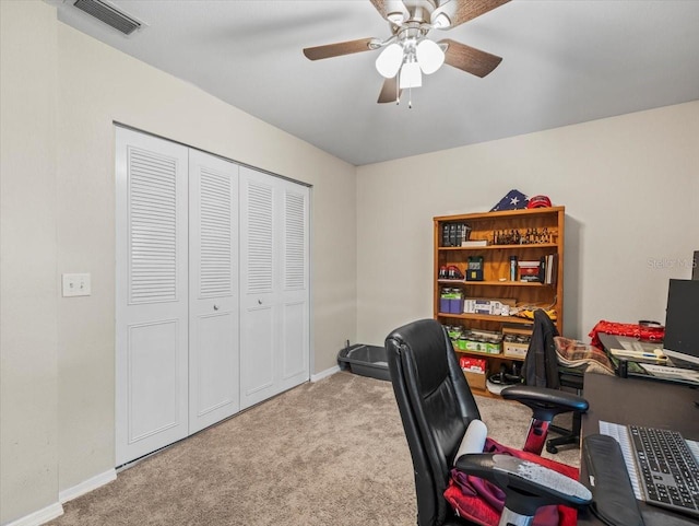 office space with baseboards, a ceiling fan, visible vents, and carpet floors