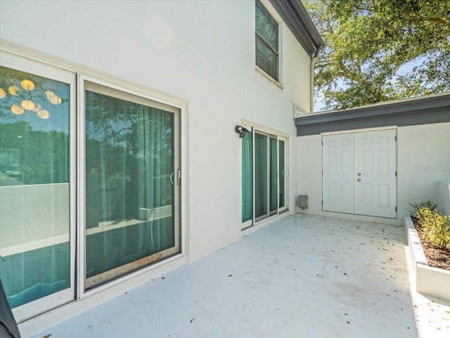 rear view of property featuring a patio area and stucco siding