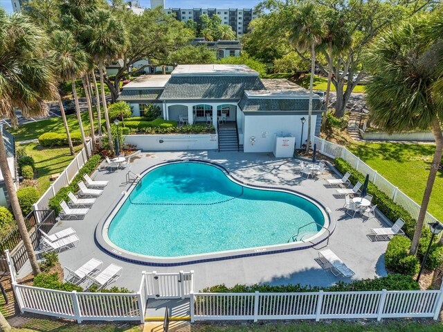 community pool featuring a patio, fence, and stairs