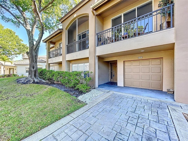810 Island Walk Dr Unit 810, Tampa, FL 33602 - view of building exterior featuring an attached garage and decorative driveway