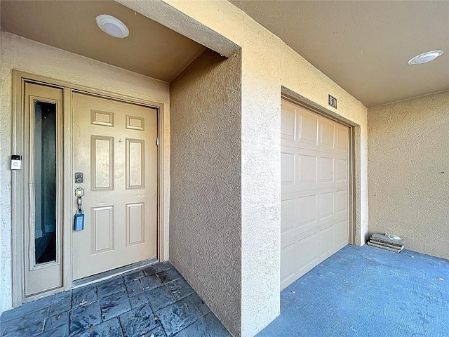 810 Island Walk Dr Unit 810, Tampa, FL 33602 - view of exterior entry with a garage and stucco siding