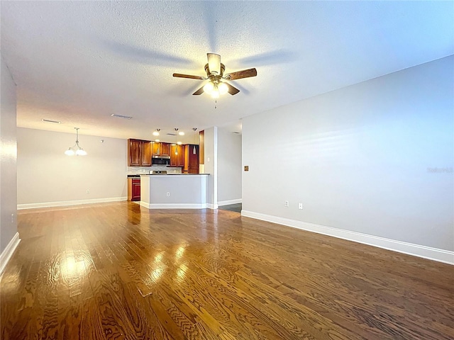 810 Island Walk Dr Unit 810, Tampa, FL 33602 - unfurnished living room with ceiling fan, a textured ceiling, baseboards, and dark wood-style flooring