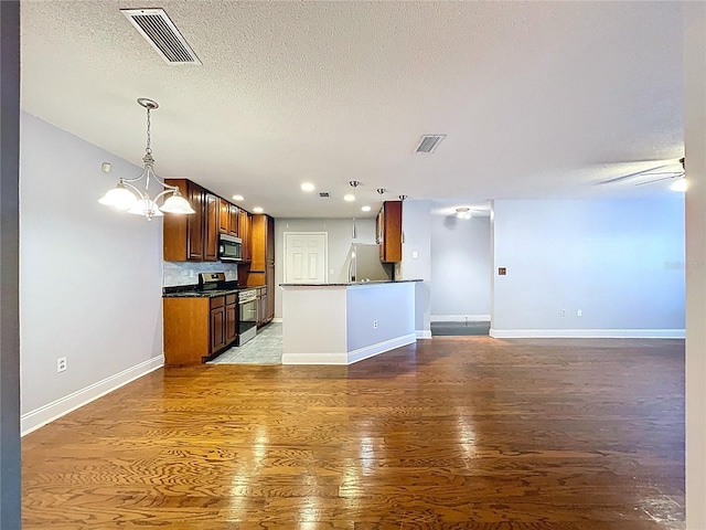 810 Island Walk Dr Unit 810, Tampa, FL 33602 - kitchen with open floor plan, dark countertops, appliances with stainless steel finishes, and visible vents