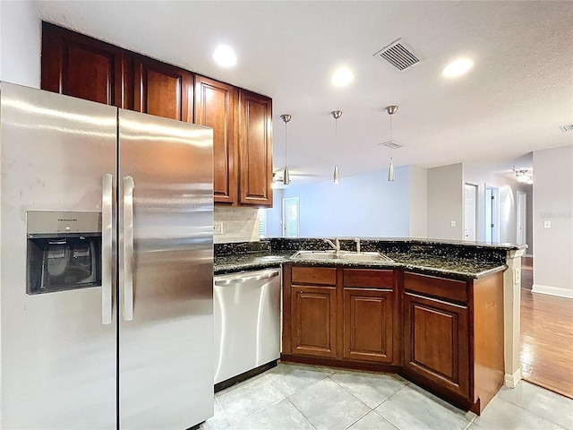 810 Island Walk Dr Unit 810, Tampa, FL 33602 - kitchen featuring a peninsula, a sink, dark stone counters, visible vents, and appliances with stainless steel finishes