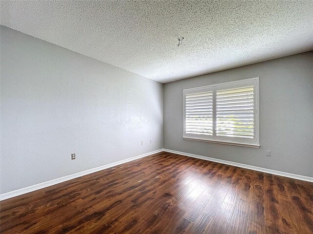 810 Island Walk Dr Unit 810, Tampa, FL 33602 - empty room with dark wood finished floors, a textured ceiling, and baseboards
