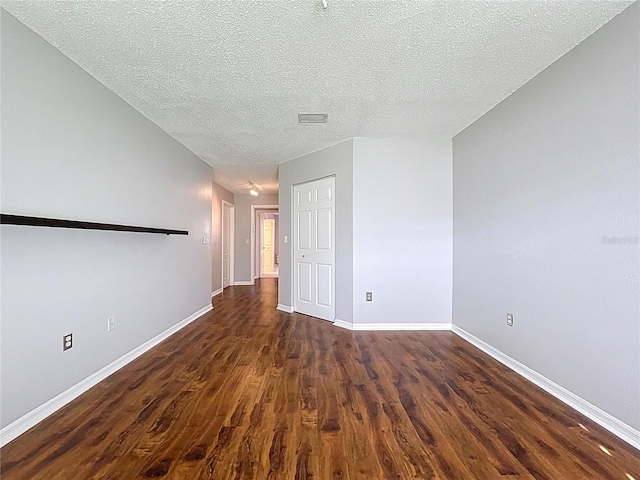 810 Island Walk Dr Unit 810, Tampa, FL 33602 - spare room featuring baseboards, dark wood-style flooring, a textured ceiling, and visible vents