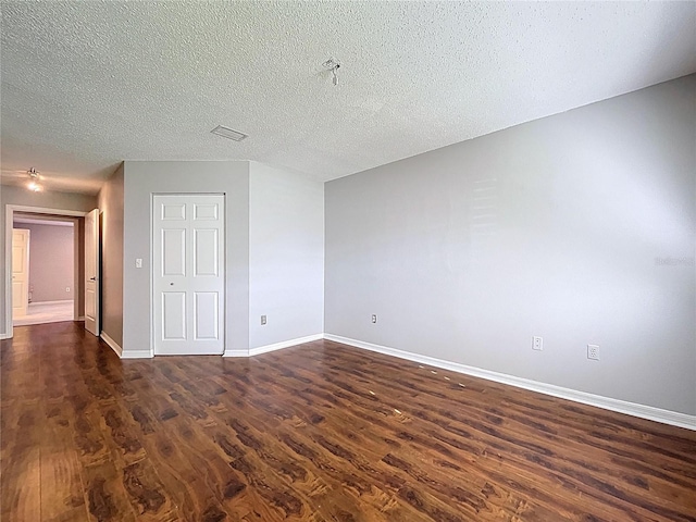 810 Island Walk Dr Unit 810, Tampa, FL 33602 - unfurnished room featuring dark wood-type flooring, a textured ceiling, baseboards, and visible vents