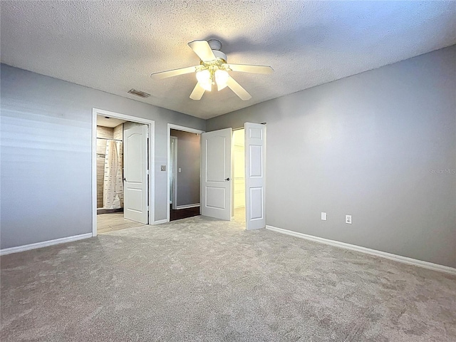 810 Island Walk Dr Unit 810, Tampa, FL 33602 - unfurnished bedroom with a textured ceiling, visible vents, baseboards, and light carpet