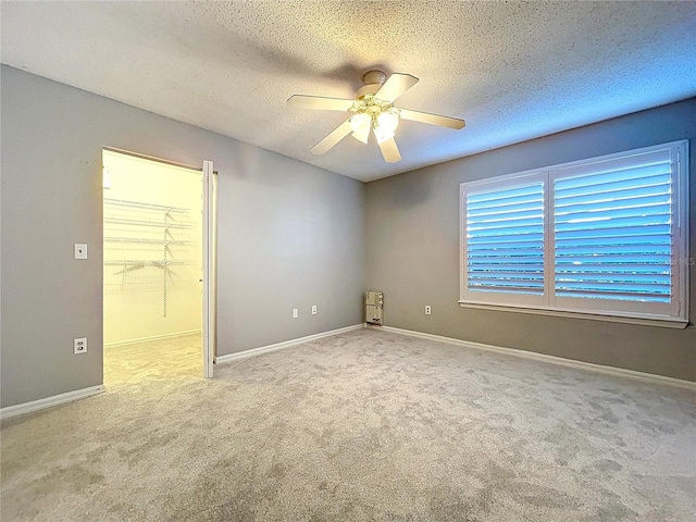 810 Island Walk Dr Unit 810, Tampa, FL 33602 - carpeted spare room with a textured ceiling, a ceiling fan, and baseboards