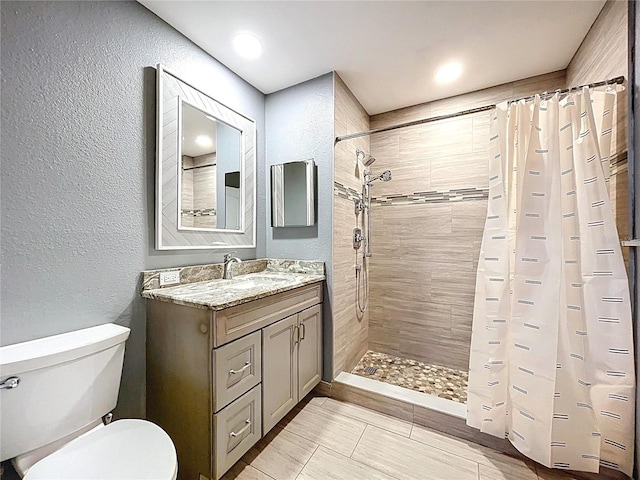 810 Island Walk Dr Unit 810, Tampa, FL 33602 - full bath featuring tile patterned floors, toilet, tiled shower, a textured wall, and vanity