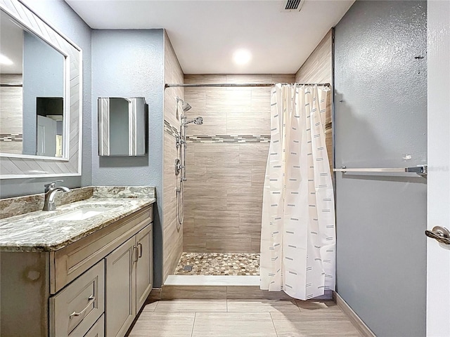 810 Island Walk Dr Unit 810, Tampa, FL 33602 - bathroom with baseboards, vanity, and tiled shower