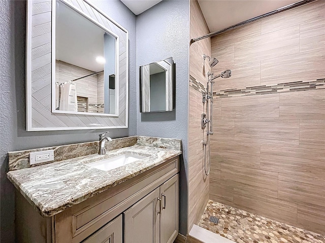 810 Island Walk Dr Unit 810, Tampa, FL 33602 - bathroom with a textured wall, vanity, and tiled shower