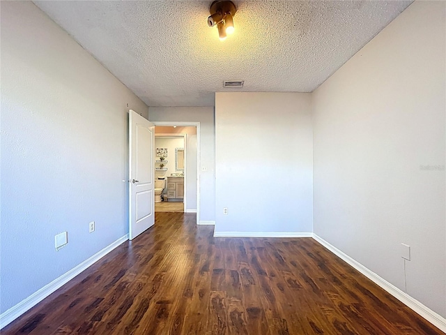 810 Island Walk Dr Unit 810, Tampa, FL 33602 - spare room with dark wood finished floors, baseboards, a textured ceiling, and visible vents