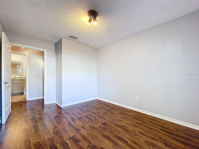 810 Island Walk Dr Unit 810, Tampa, FL 33602 - spare room with dark wood finished floors, visible vents, a sink, baseboards, and a textured ceiling