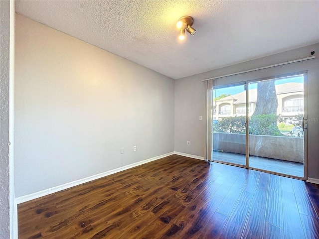 810 Island Walk Dr Unit 810, Tampa, FL 33602 - unfurnished room featuring baseboards, a textured ceiling, and dark wood-style floors
