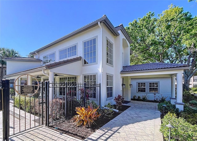 810 Island Walk Dr Unit 810, Tampa, FL 33602 - view of front of house featuring a gate, a tiled roof, stucco siding, ceiling fan, and fence private yard
