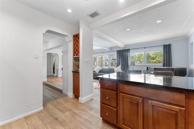 807 W Braddock St, Tampa, FL 33603 - kitchen with brown cabinets, visible vents, light wood-type flooring, and baseboards