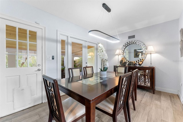 807 W Braddock St, Tampa, FL 33603 - dining area featuring french doors, visible vents, baseboards, and light wood-style floors