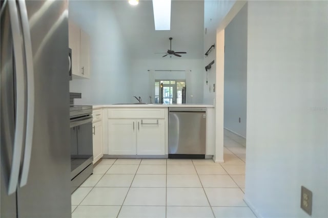kitchen featuring a sink, light tile patterned flooring, ceiling fan, light countertops, and appliances with stainless steel finishes