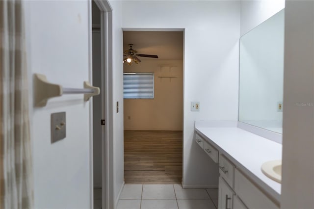bathroom with baseboards, a ceiling fan, vanity, and tile patterned flooring