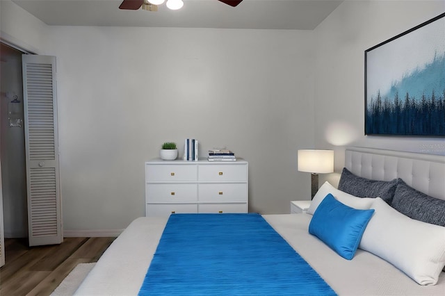 bedroom featuring baseboards, a ceiling fan, and wood finished floors