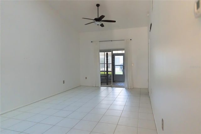 empty room featuring high vaulted ceiling, ceiling fan, and light tile patterned floors