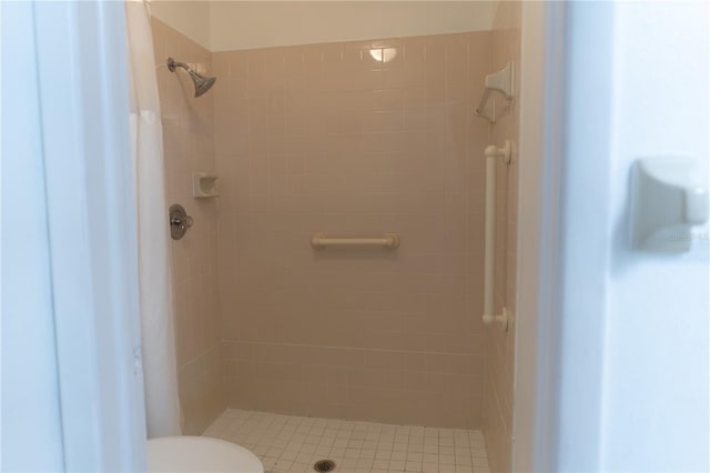 bathroom featuring toilet and a stall shower