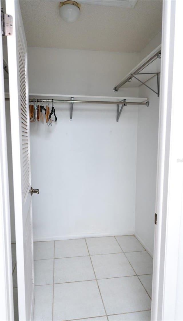 spacious closet featuring light tile patterned floors