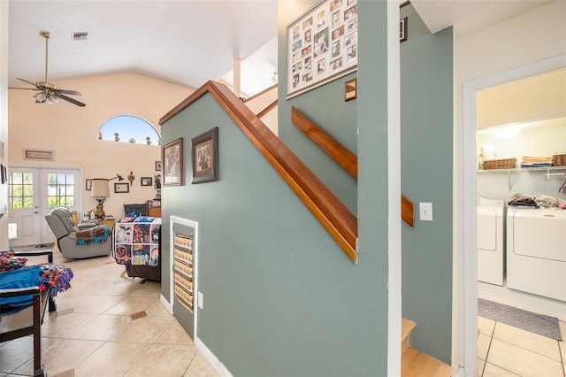 8704 Tarrington Pl, Tampa, FL 33635 - corridor with washing machine and clothes dryer, light tile patterned floors, vaulted ceiling, and stairway