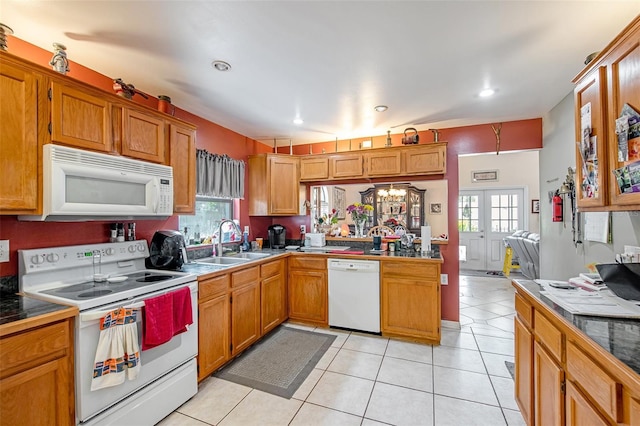 8704 Tarrington Pl, Tampa, FL 33635 - kitchen with white appliances, a sink, healthy amount of natural light, light tile patterned flooring, and recessed lighting