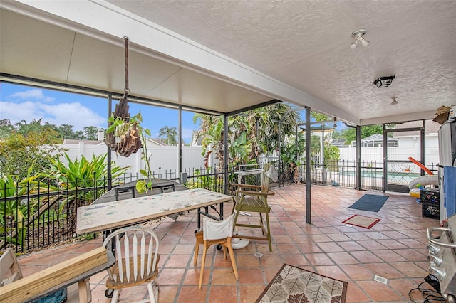 8704 Tarrington Pl, Tampa, FL 33635 - sunroom with a textured ceiling, plenty of natural light, outdoor dining area, and a wall of windows