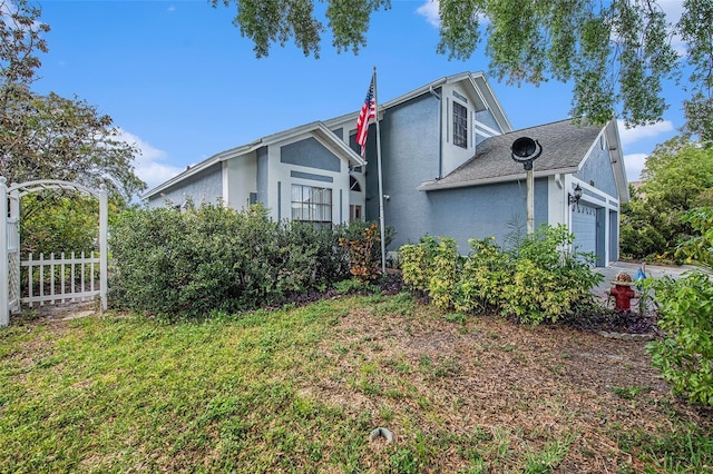 8704 Tarrington Pl, Tampa, FL 33635 - view of side of home with stucco siding and an attached garage