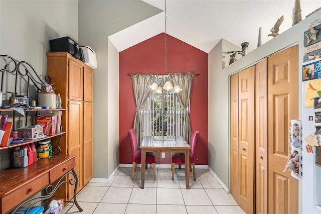 8704 Tarrington Pl, Tampa, FL 33635 - dining room with lofted ceiling, light tile patterned floors, and baseboards
