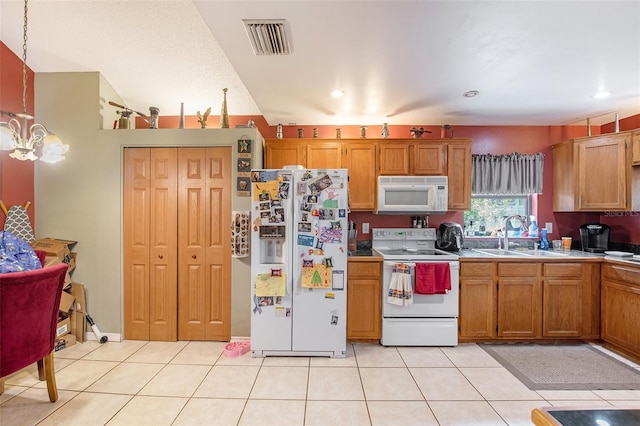 8704 Tarrington Pl, Tampa, FL 33635 - kitchen featuring white appliances, a sink, brown cabinetry, light tile patterned floors, and recessed lighting